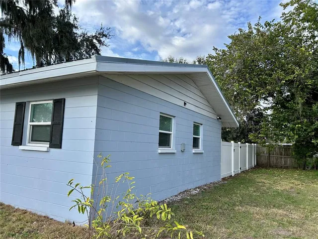 a backyard of a house with lots of green space