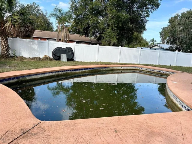 a view of a swimming pool with a patio