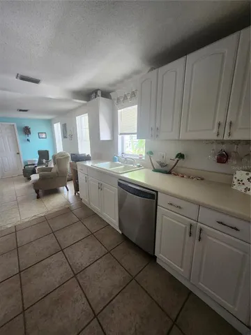 a kitchen with a sink cabinets and window