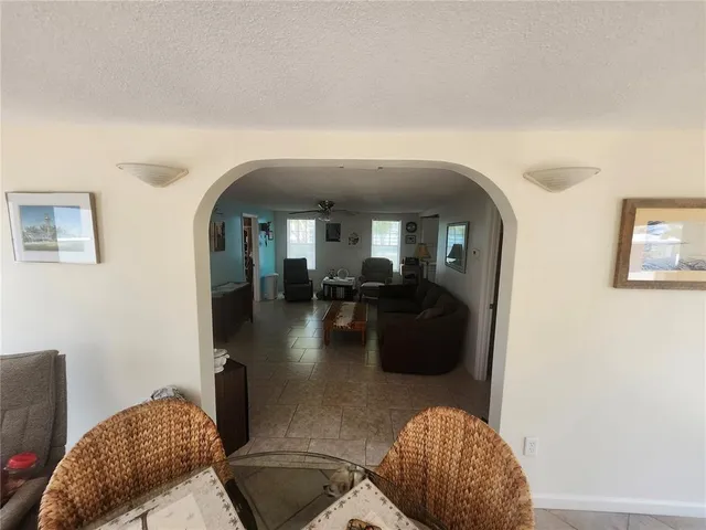 a living room with furniture and a mirror
