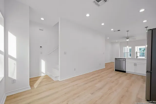 a room with wooden floor and window