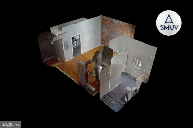 a view of a kitchen with fridge and workspace