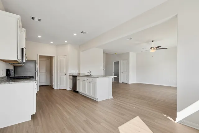 a view of a kitchen with wooden floor