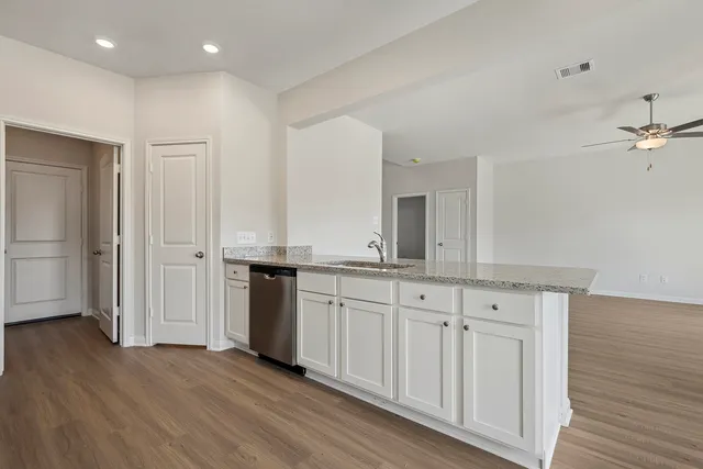 a spacious bathroom with a granite countertop sink