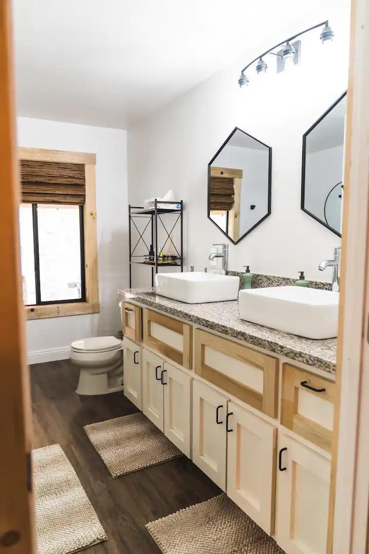 33209 Road 222 North Fork, CA 93643 - Photo 11 of 23 a bathroom with a double vanity sink a toilet and a mirror