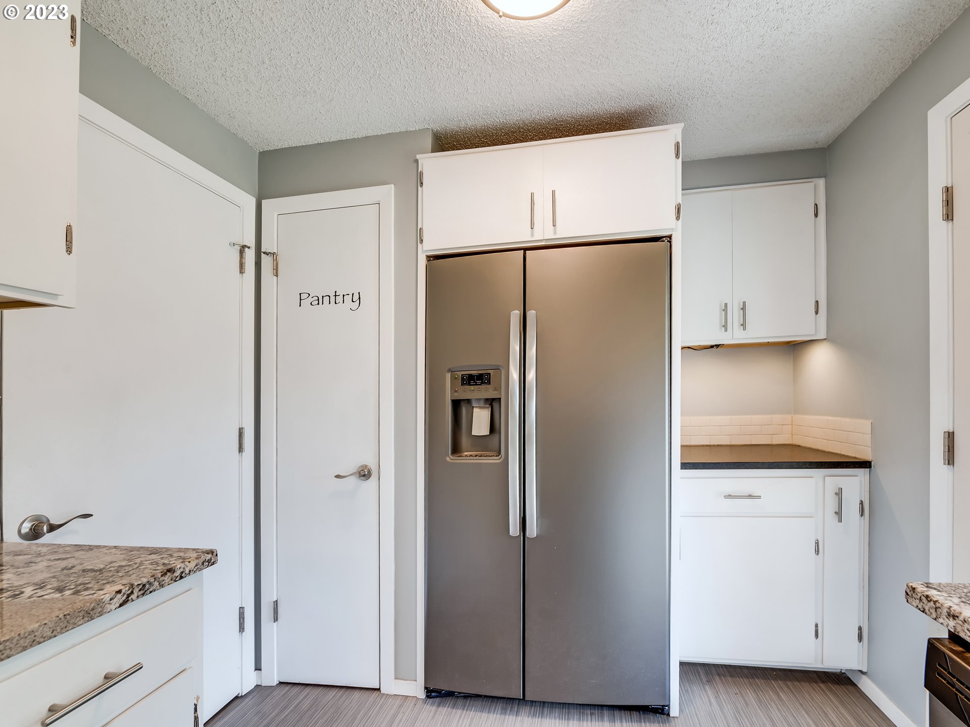 320 36th Street Springfield, OR 97478 - Photo 11 of 26 a metallic refrigerator freezer sitting in a kitchen