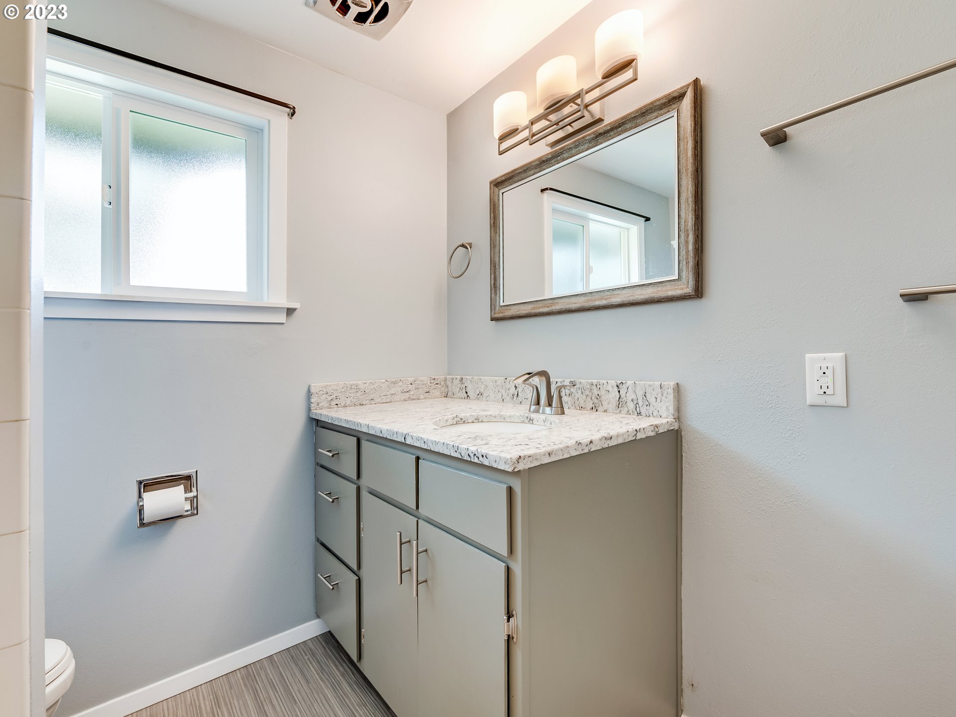320 36th Street Springfield, OR 97478 - Photo 17 of 26 a bathroom with a granite countertop sink a toilet and a mirror