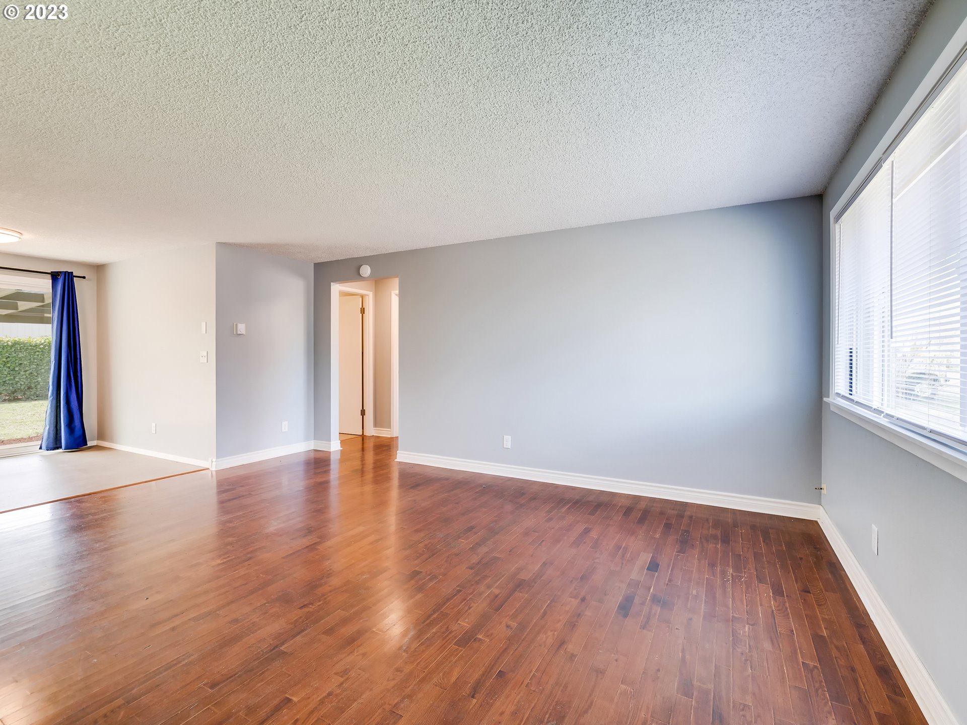 320 36th Street Springfield, OR 97478 - Photo 4 of 26 a view of an empty room with wooden floor and window