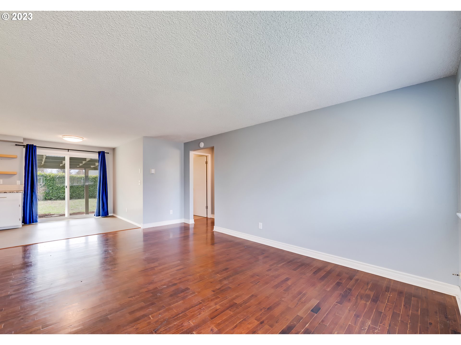 320 36th Street Springfield, OR 97478 - Photo 5 of 26 a view of an empty room with wooden floor and windows