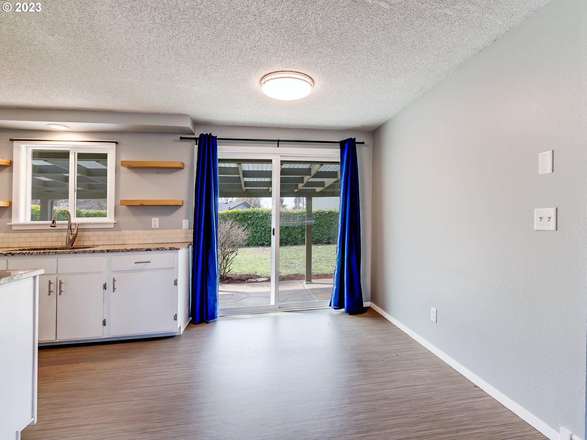320 36th Street Springfield, OR 97478 - Photo 6 of 26 an empty room with wooden floor and balcony