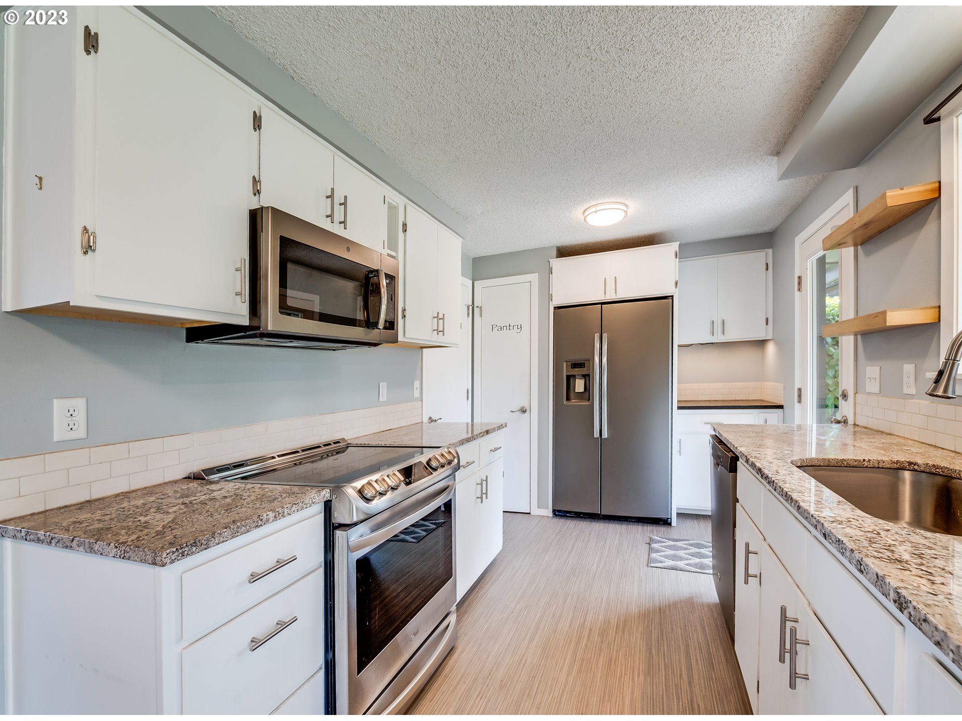 320 36th Street Springfield, OR 97478 - Photo 9 of 26 a kitchen with stainless steel appliances granite countertop a refrigerator stove and sink