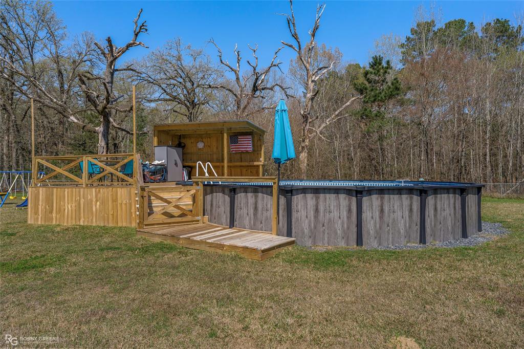 396 Collinswood Road Stonewall, LA 71078 - Photo 3 of 32 a view of a house with wooden fence