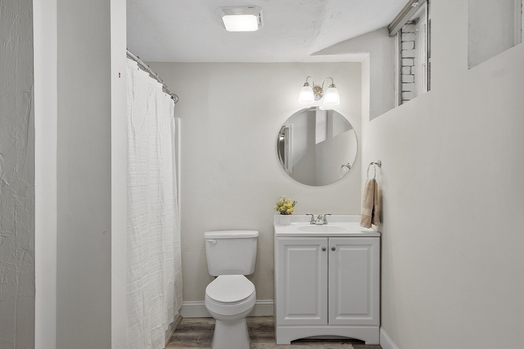 31 Elizabeth Street, Unit G3 Worcester, MA 01605 - Photo 16 of 28 a bathroom with a toilet sink and mirror