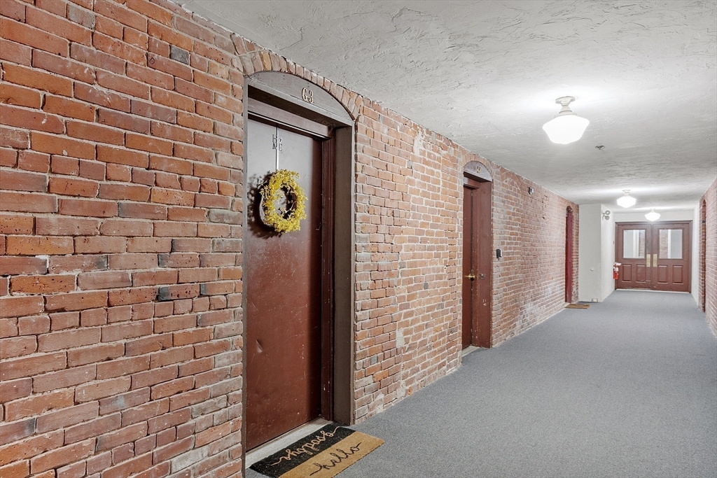 31 Elizabeth Street, Unit G3 Worcester, MA 01605 - Photo 4 of 28 a view of a hallway with brick walls