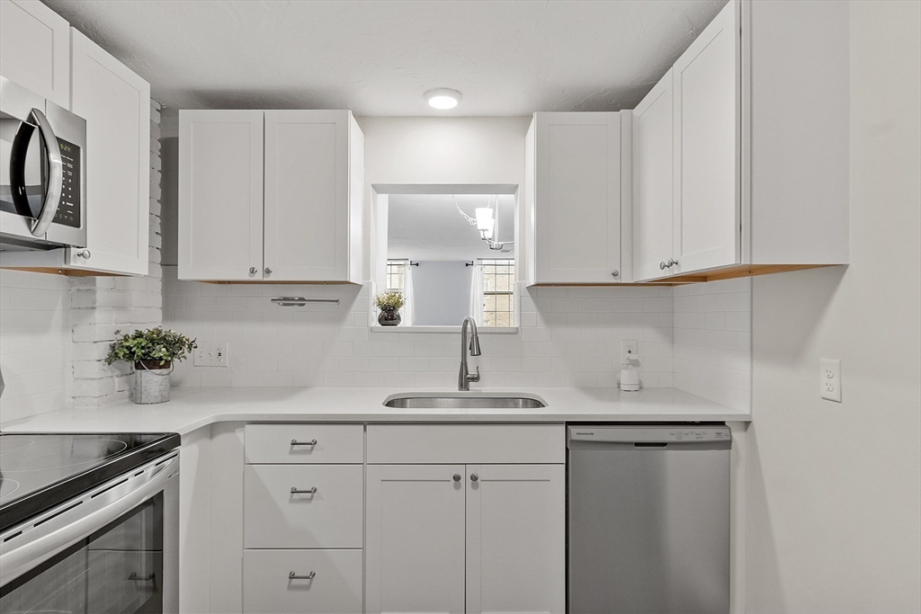31 Elizabeth Street, Unit G3 Worcester, MA 01605 - Photo 7 of 28 a kitchen with stainless steel appliances white cabinets and a sink