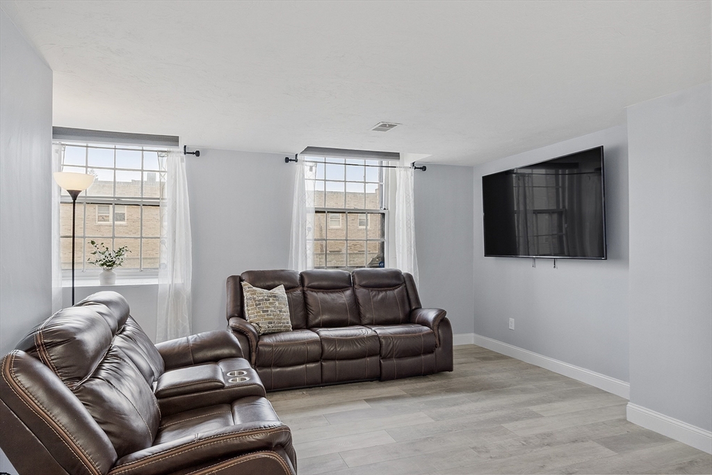 31 Elizabeth Street, Unit G3 Worcester, MA 01605 - Photo 9 of 28 a living room with furniture and a flat screen tv