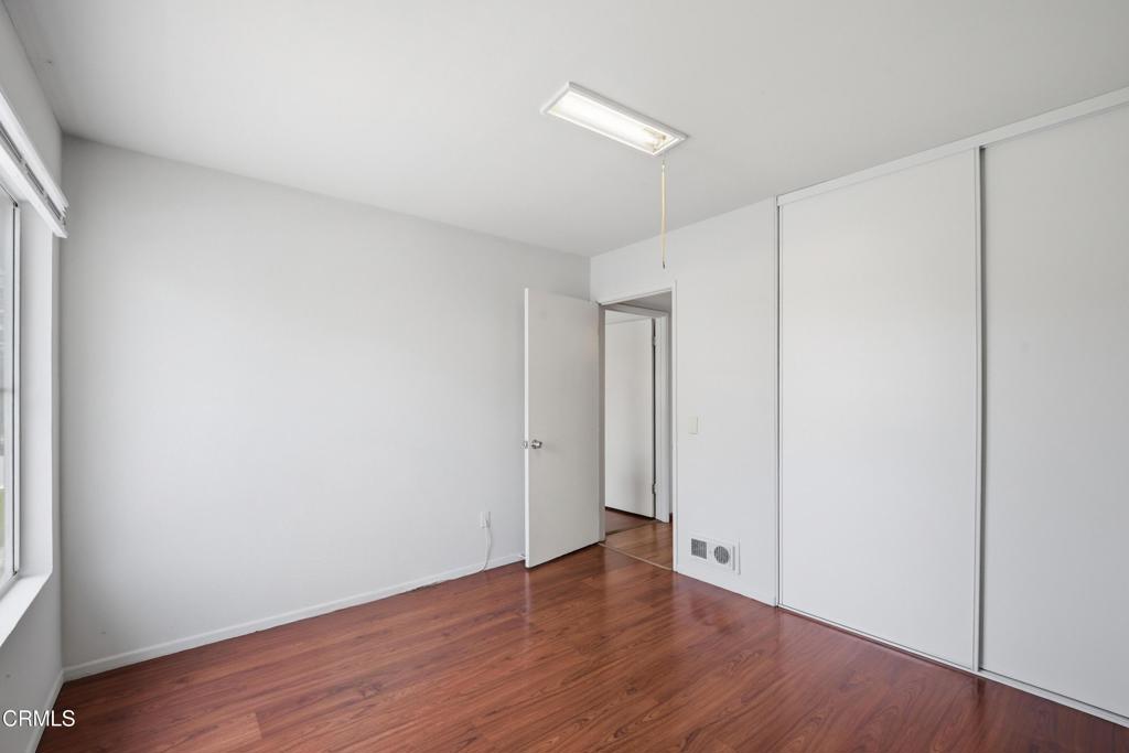 5154 Jefferson Square Oxnard, CA 93033 - Photo 19 of 23 a view of an empty room with wooden floor