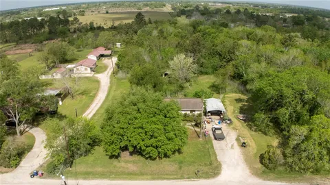 an aerial view of a house with a yard basket ball court and outdoor seating