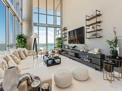 a living room with furniture large window and flat screen tv