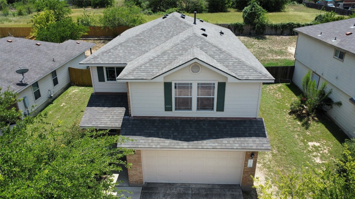 a aerial view of a house with a yard