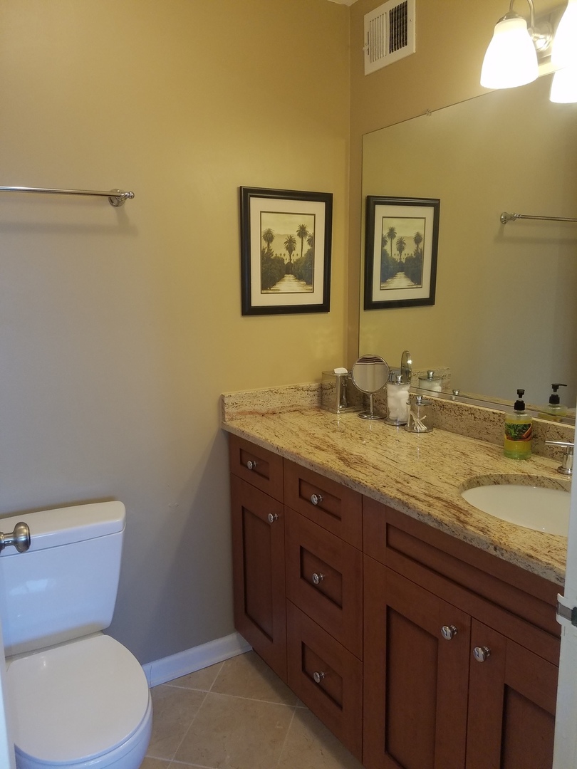 Undisclosed Address Chicago, IL 60613 - Photo 8 of 16 a bathroom with a granite countertop toilet sink and mirror