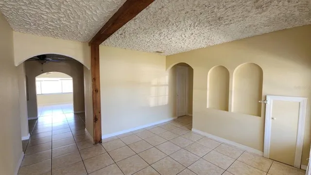 a view of a hallway with wooden shelves