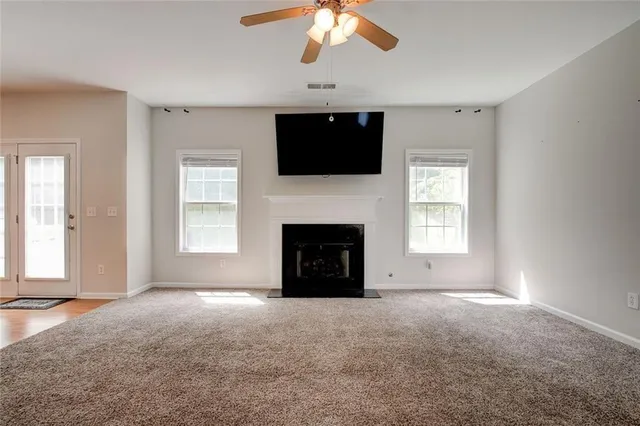 a view of livingroom with a fireplace fan and window