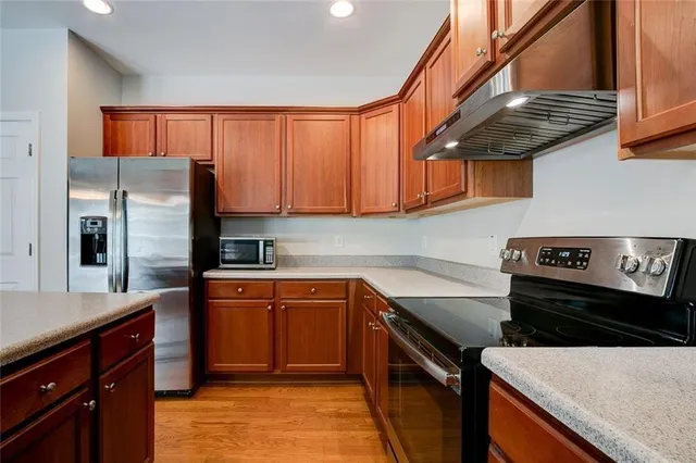a kitchen with stainless steel appliances granite countertop a stove a sink and dishwasher