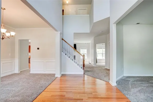 a view of staircase with white walls and door