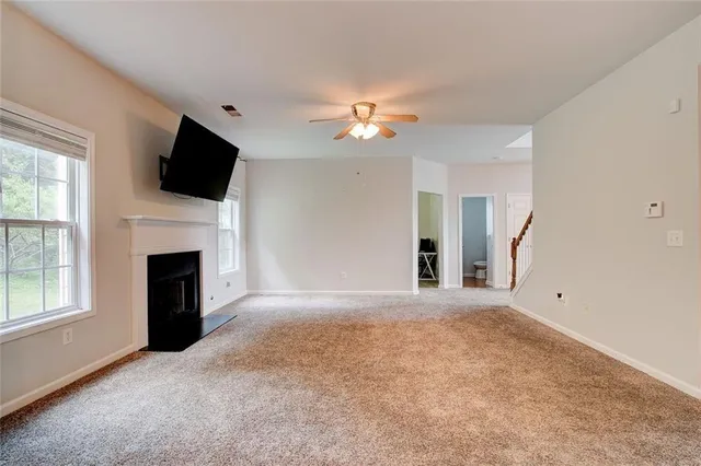 a view of a livingroom with an empty space and a fireplace