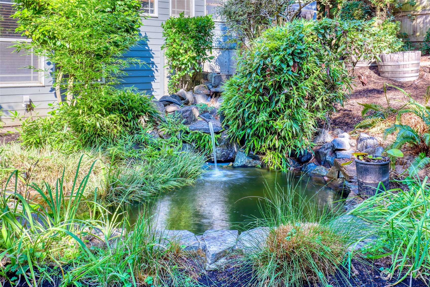 23303 8th Place West Bothell, WA 98021 - Photo 27 of 33 a backyard of a house with a garden and plants