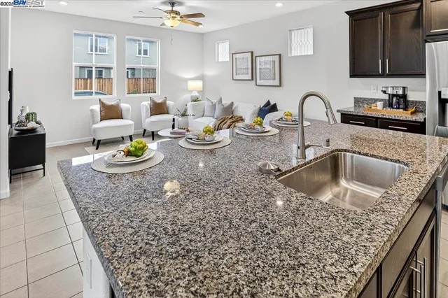 a kitchen with a sink a stove and cabinets with wooden floor
