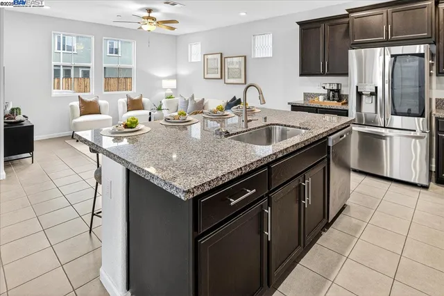 a kitchen with a sink a stove and cabinets