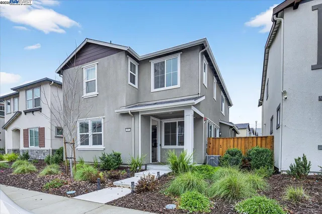 a front view of a house with plants and entryway