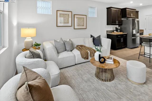 a living room with furniture and kitchen view