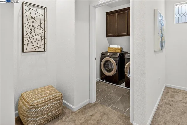 a utility room with sink dryer and washer