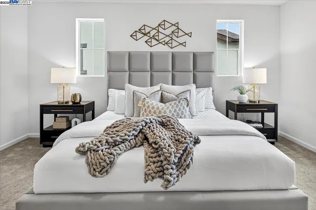 a spacious bedroom with a bed and a lamp