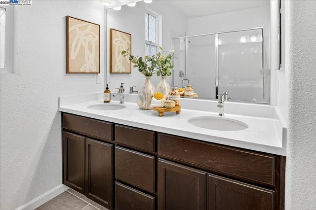 a bathroom with a sink double vanity and a mirror