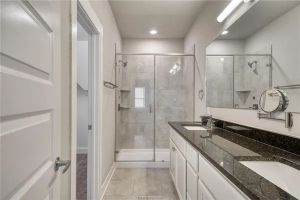 a spacious bathroom with a granite countertop sink mirror and double