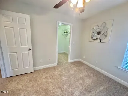 an empty room with windows and cabinet