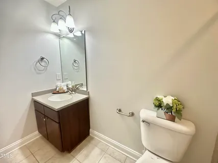 a bathroom with a sink toilet and mirror
