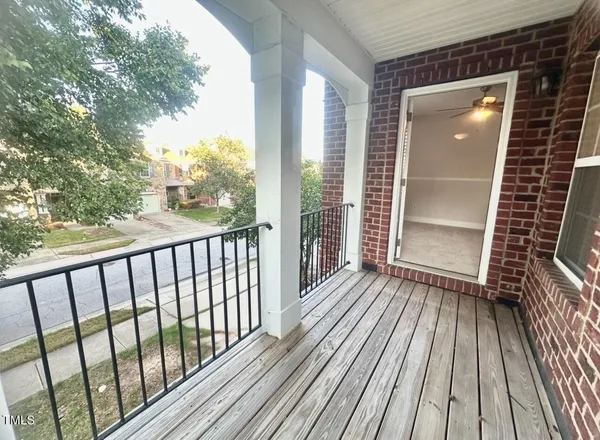 a view of a balcony with wooden floor