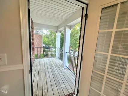 a view of balcony with wooden floor
