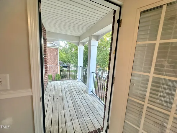 a view of balcony with wooden floor