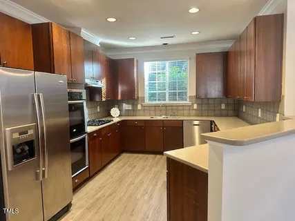a kitchen with a sink stove and refrigerator