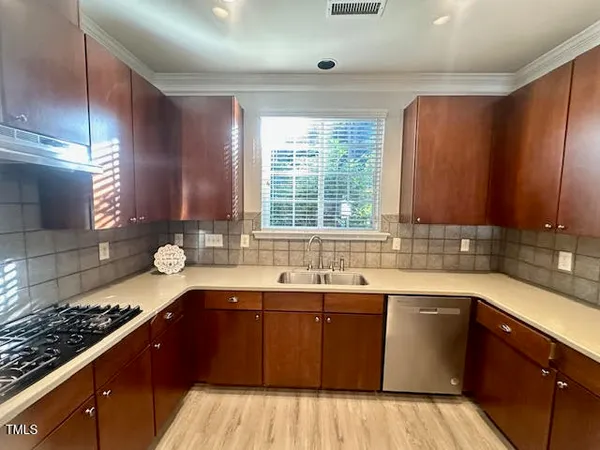 a kitchen with a sink stove and cabinets
