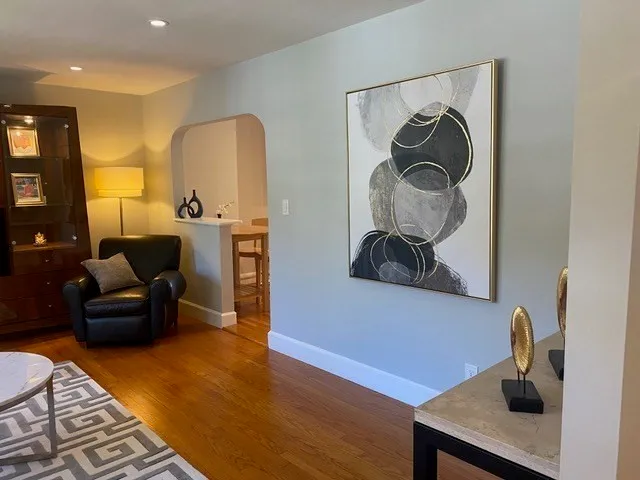 a living room with furniture and a wooden floor
