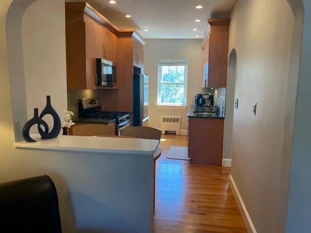 a kitchen with stainless steel appliances granite countertop a sink and wooden cabinets