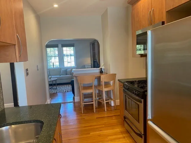 a kitchen with stainless steel appliances granite countertop a stove and a refrigerator