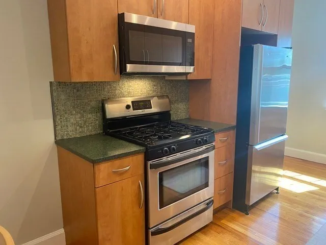a kitchen with a stove and a microwave